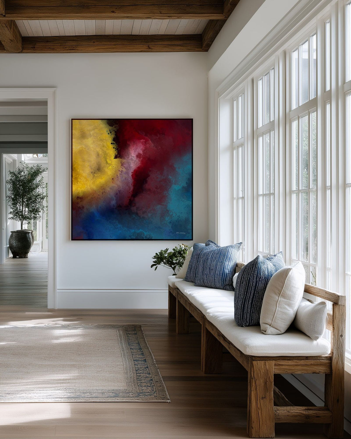 Let There Be Light, Genesis 1:3 canvas print above a cushioned bench beside a wall of windows