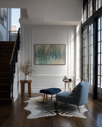 Revealed In Jesus, Romans 8:39 canvas print on a panelled wall beside a staircase and a blue armchair